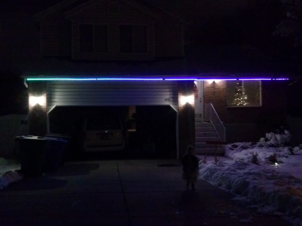 Josh got ligths up on my parents house, and was about to do them for our house when...it snowed. But that didn't stop Josh! He only got part of the house lit; but, but they were still super cool! 